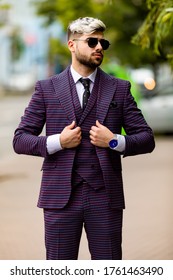 Man In Glasses And Violet Luxery Three-piece Suit, Bow Tie Posing On The Street