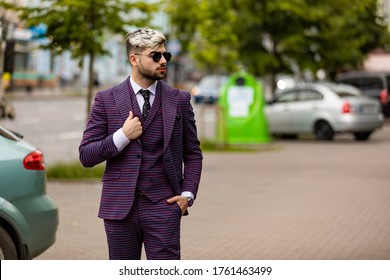 Man In Glasses And Violet Luxery Three-piece Suit, Bow Tie Posing On The Street