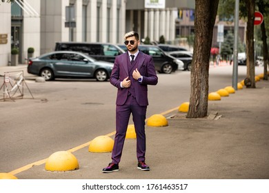 Man In Glasses And Violet Luxery Three-piece Suit, Bow Tie Posing On The Street