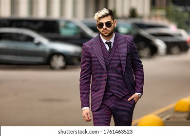 Man In Glasses And Violet Luxery Three-piece Suit, Bow Tie Posing On The Street