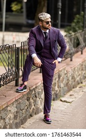 Man In Glasses And Violet Luxery Three-piece Suit, Bow Tie Posing On The Street