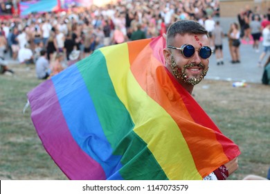 Man With Glitter Beard Holding Rainbow Flag 