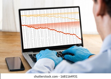 Man In Gloves Checking Stock Charts During Coronavirus Stock Market Crash