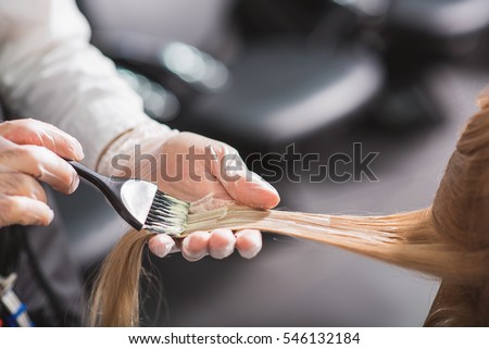 Man in gloves is dying hair