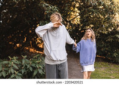 Man Go Away From His Wife, He Cover His Face, Crying, His Woman Try To Stop Him, Say Sorry, Scream. Couple Walk In Park, Problem In Relationship.  Couple Arguing, Sad Man.