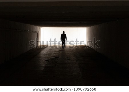 The man goes to the light in the tunnel