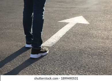 Man Going Along Road With Arrow Marking, Closeup