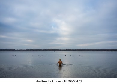 Man Going Into A Lake To Have A Swim In Cold Water In Autumn 