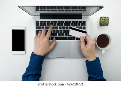 A Man Is Going To Pay For The Goods In The Internet Using Credit Card And Laptop Computer. Online Shopping Concept.