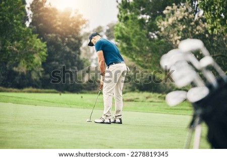 Man, golf ball and putter on grass to ready for game, sport and aim shot in competition with focus outdoor. Professional golfer, start and put shooting for contest on field, lawn and course in summer