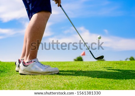 man golf player concentrate in hit the golf ball away to the destination green for winning in score rate