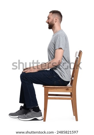 Man with good posture sitting on chair against white background