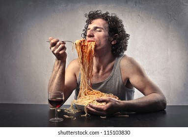 Man gorging of red spaghetti