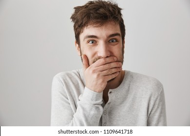 Man Got Insane. Portrait Of Weird Crazy Guy With Messy Haircut Laughing And Looking With Strange Expression At Camera, Standing Over Gray Background, Posing Like Psychopath. Male Lost His Mind