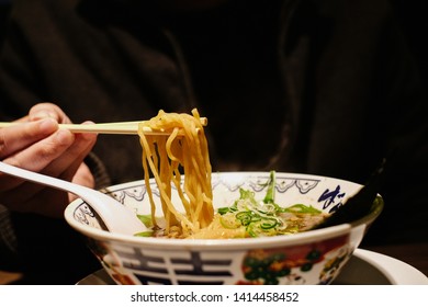 Man Grab Ramen Noodle Out Of Bowl By Chopsticks