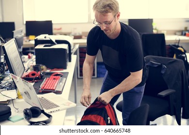 Man Grabbing Backpack Leaving After Work Hour