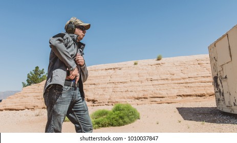 Man Grabbing Pistol From Holster On Desert Range Conceal Carry