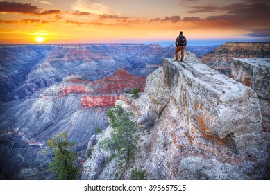  man in the Grand Canyon at sunrise. tourist in America