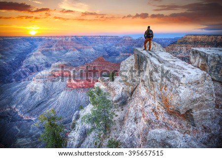  man in the Grand Canyon at sunrise. tourist in America