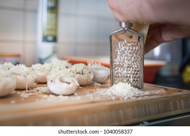 Man Grate Cheese For Stuffed Mushrooms With Blue Cheese