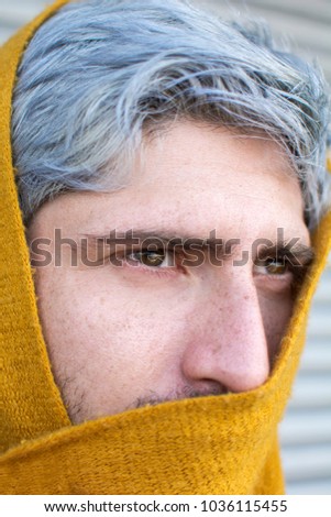 Man with gray hair and yellow turban.