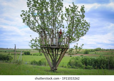 A Man In The Green Treehouse. Rural Tourism In Spring Time. Eco-village Concept In Harmony With Nature.