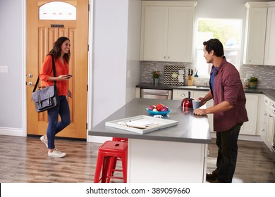 Man Greeting Woman Returning Home From Work