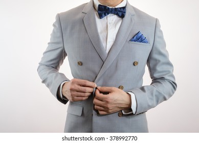 Man In Grey Suit, Plaid Texture, Blue Bowtie And Pocket Square, Close Up White Background