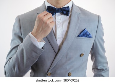 Man In Grey Suit, Plaid Texture, Blue Bowtie And Pocket Square, Close Up White Background