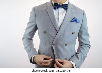 Man In Grey Suit, Plaid Texture, Blue Bowtie And Pocket Square, Close Up White Background