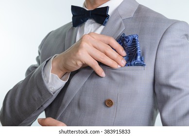 Man In Grey Suit, Plaid Texture, Blue Bowtie And Pocket Square, Close Up White Background