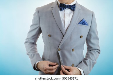 Man In Grey Suit, Plaid Texture, Blue Bowtie And Pocket Square, Close Up White Background