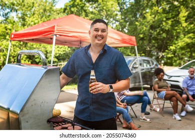 Man Grilling On The Bbq At A Tailgate Party