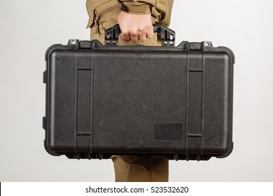 Man Or Guard Hand Holding Case With Weapon Isolated At White Background. Military And Security Concept.