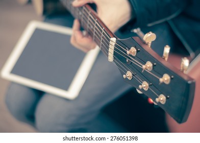 Man With Guitar And White Ipad