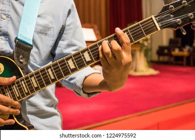 A Man, Guitarist, Playing Electric Guitar In Christian Worship In The Church.