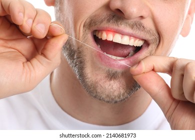 Man With Gum Inflammation Flossing Teeth, Closeup