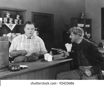 Man With A Gun Holding Up A Diner Owner