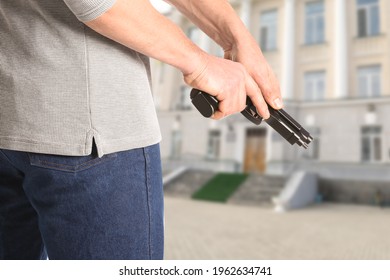 Man With Gun Near School Outdoors