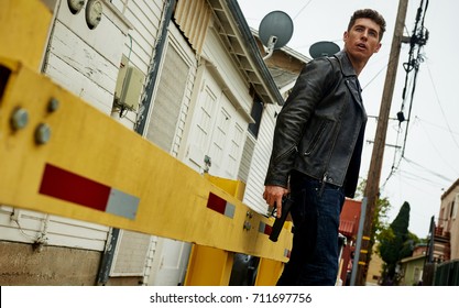 A Man With A Gun Out Back Waiting For Someone, Looking For Trouble.