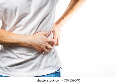 man, guy in a white t shirt on a white background hold hands on his stomach,  liver pain, pancreas, kidneys problems - Shutterstock ID 737556040
