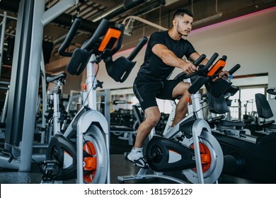 Man At Gym Riding Bike.