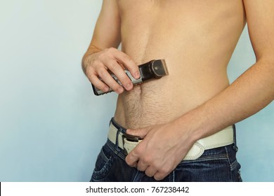 Man Haircut Pubic Hair And The Hair On The Abdomen With A Clipper. Concept Of A Clean Healthy Body For Men.