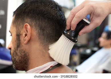 Man at the hairdresser while being cleaned and brush