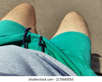 Man With Hairy Legs In Green Shorts