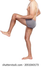 A Man With Hairy Legs In Shorts. Full Height. Isolated On White Background. Vertical.