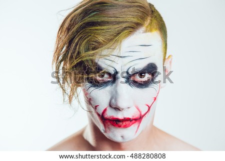 man with halloween face art on white background