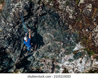 A Man With Hamlet On, Climbing On The Rock By Himself, Top View.