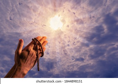 Man hand with beads praying god.