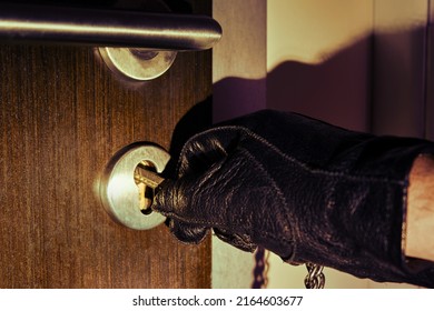 Man Hand In A Black Glove Opens The Office Door In The Night Light Of A Flashlight